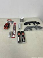 Full view of tool items showing wire strippers, wire spool, scrapers, blades and pins