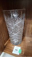 Front view of large crystal vase showing overall shape and cut pattern.