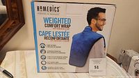 Front and side views of product box showing the product brand, features, and image of man wearing the weighted comfort wrap.