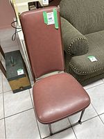 Single dusty rose vinyl chair showing backrest, seat and metal legs.