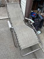 Full view of zero gravity chair showing metal frame, fabric seating, and armrests.