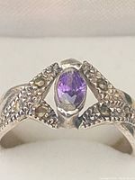 Close-up front view showing oval amethyst gemstone and marcasite accents.