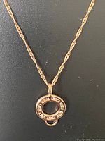 Close-up photo of the round pendant with cubic zirconia stones set in sterling silver.