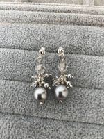 Front view of both sterling silver earrings showing gray pearl drops, crystal beads, and small silver bead clusters.