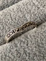 Close-up of the sterling silver band with marcasite stone detail and beaded pattern.