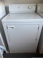 Front view of white Admiral electric clothes dryer showing front-loading door with handle, illustrating overall exterior condition and size.