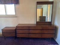 Straight-on view of walnut dresser with mirror in bedroom
