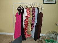 Dresses on clothing rack showing all 10 dresses front side, different colors and patterns visible.