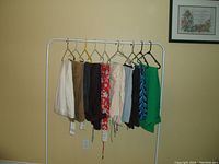 Photo of 10 women's pants on hangers on a rack, showing various colors and some with tags, size 1X by ZARA