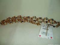 Photo of ZARA gold color metal belt with multi-colored stones and attached tag showing it is new with tag.