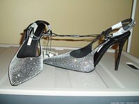 Photo shows a pair of black ZARA women's ankle wrap shoes adorned with rhinestones, size 8, new with tag attached, featuring pointed toes and stiletto heels.