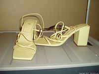Pair of ZARA pale yellow ankle wrap high-heeled shoes, size 8, new with tags attached.