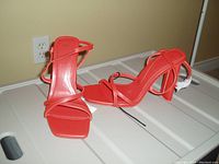Photo showing a pair of orange ZARA women's heeled sandals, size 8, new with tags, displayed on a white surface against a yellow wall.