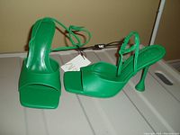 Pair of green high heel ZARA shoes, size 8, new with tags still attached, featuring ankle straps and square toe design.