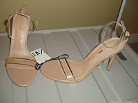 Pair of ZARA women's high heel shoes, size 8, with clear straps on ankle and toes, beige heel and insole, new with tags.