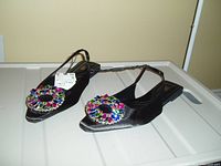Photo showing pair of black ZARA slides size 8 with colorful jewel embellishments on the front and slingback straps, displayed on a white surface.