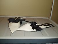 Photo showing pair of off white Zara slides with pointed toes and black bow detail from top front angle