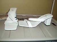 Pair of white ZARA women's heeled sandals with block heels and square toes, new with tags, displayed on a flat surface.