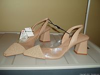 Side view of tan ZARA slingback shoes showing pointed toe with textured front and clear sides, block heel, and attached tags.