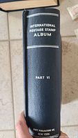 Spine of black hardcover International Postage Stamp Album Part VI album by Scott Publications, New York.