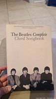 Front cover of 'The Beatles Complete Chord Songbook' showing the title and black and white photograph of The Beatles.