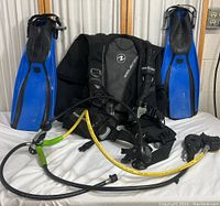 Full set of diving equipment with fins, BCD, and regulator shown together