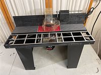 Front view of the Sears Craftsman Industrial Router Table showing the extended grid-style table and transparent safety guard.