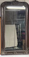 Full view of the large rectangular ornate framed mirror showing overall shape, size, and condition.