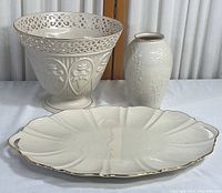 Full view of all three pieces: dish, bowl, and vase showing white glaze and gold accents.