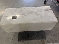 Rectangular marble base showing top surface with circular 2 inch diameter hole and natural veining.