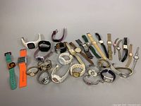 Full lot view of assorted watches in various styles and colors.