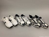 Three pairs of men's sneakers displayed side by side, showing overall condition and color variations.