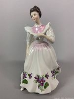 Front view of Royal Doulton February figurine showing detailed floral dress and facial features