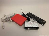 All items overview showing Blaupunkt car stereo, red adapter box, Zoom FC01 foot controller, and cables.