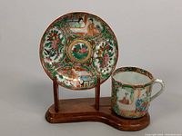 Demitasse teacup and saucer set on wooden display stand, overall view