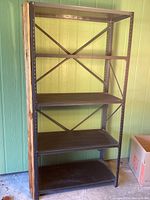 Front and side views of metal shelving unit showing four shelves and fence post detail on right side.
