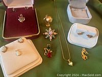 Full lot laid out showing all jewelry items including pins, earrings, and a heart pendant necklace.