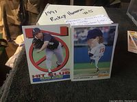 Photo showing baseball cards of Wilson Alvarez and Scott Erickson with handwritten note referencing Ricky Henderson card #5