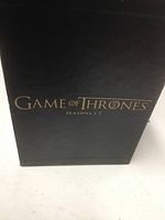 Black box set with gold text 'Game of Thrones Seasons 1-7'