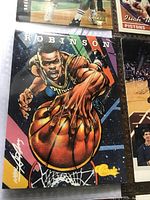 Close-up of David Robinson basketball card showing colorful artwork of him reaching for a basketball, autographed, with 'Classic' branding.