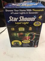 Box of Star Shower laser light showing product details for decorative outdoor lighting.