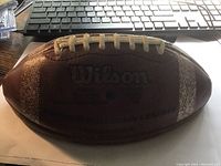 Photo of the Wilson football showing overall view and signatures