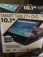 Box of the Sylvania Smart Tablet + DVD showing product image and key features such as 10.1 inch screen, Android 10 Go edition, Wi-Fi, and Google Assistant.