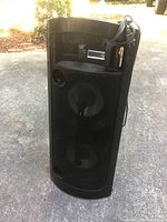 Front angle showing black speaker with mesh grille and dual drivers.