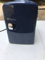 Front view of the Uberchill Mini Frig showing the door with a handle and brand logo.