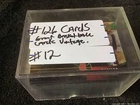 Plastic box with handwritten label showing quantity 126 cards, noted as great vintage and basketball cards.