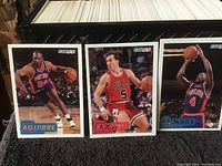 Three vintage basketball cards featuring Carl Herrera, John Paxson, and Joe Dumars from the Fleer 1990-91 series, showing players in uniform with basketball action poses.