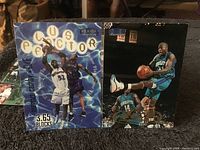 Photo showing two vintage basketball cards from Fleer Tradition series including players Anthony Mason and a Charlotte Hornets player.