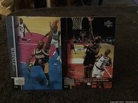 Two basketball cards including Derek Fisher and another player in action poses on a basketball court.