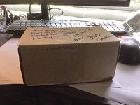 A closed cardboard box labeled 'Classic & Sports 07-94' and notes indicating over 300 cards including football, basketball, and hockey cards.